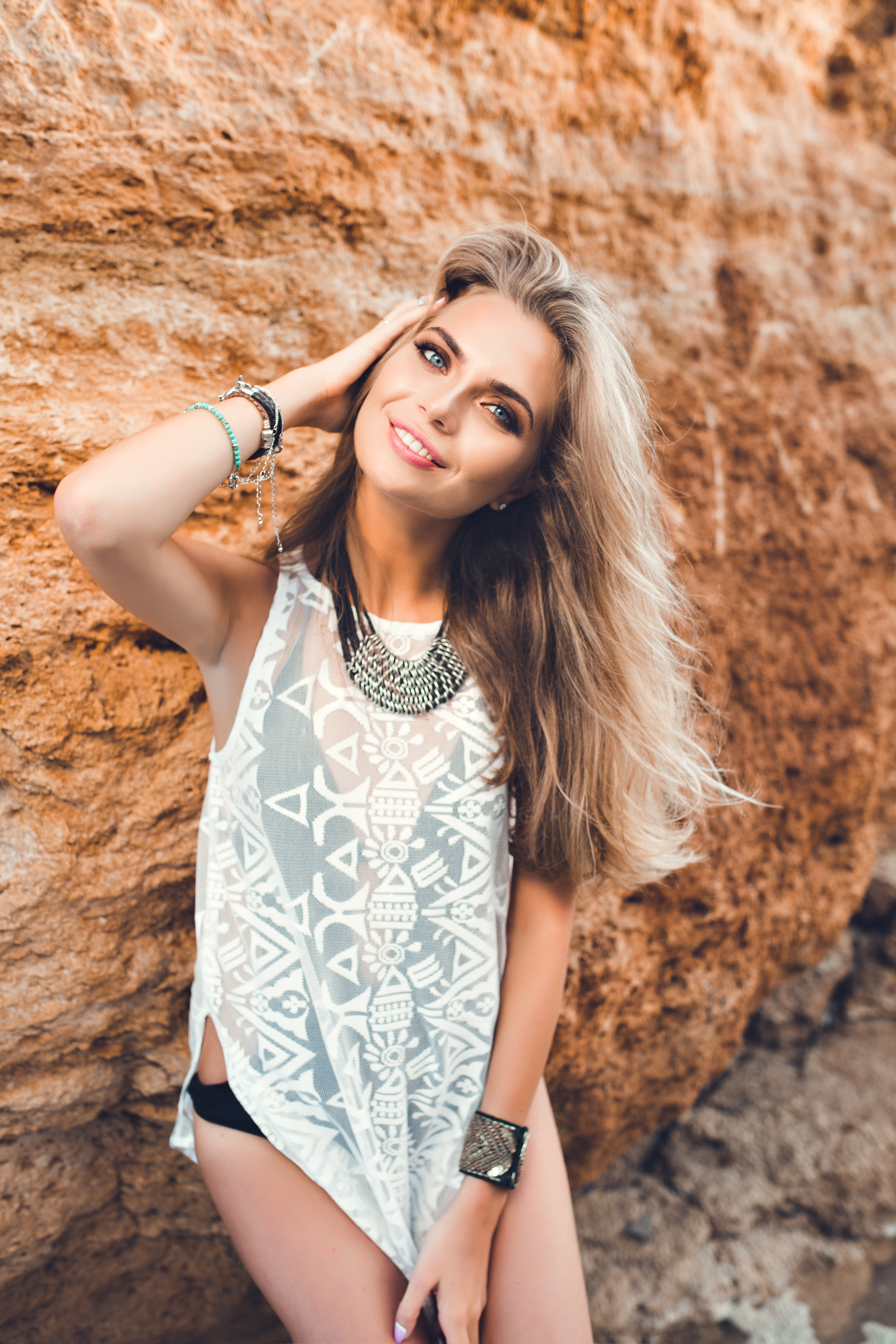 attractive-blonde-girl-with-long-hair-is-posing-camera-rock-background-she-is-smiling.jpg