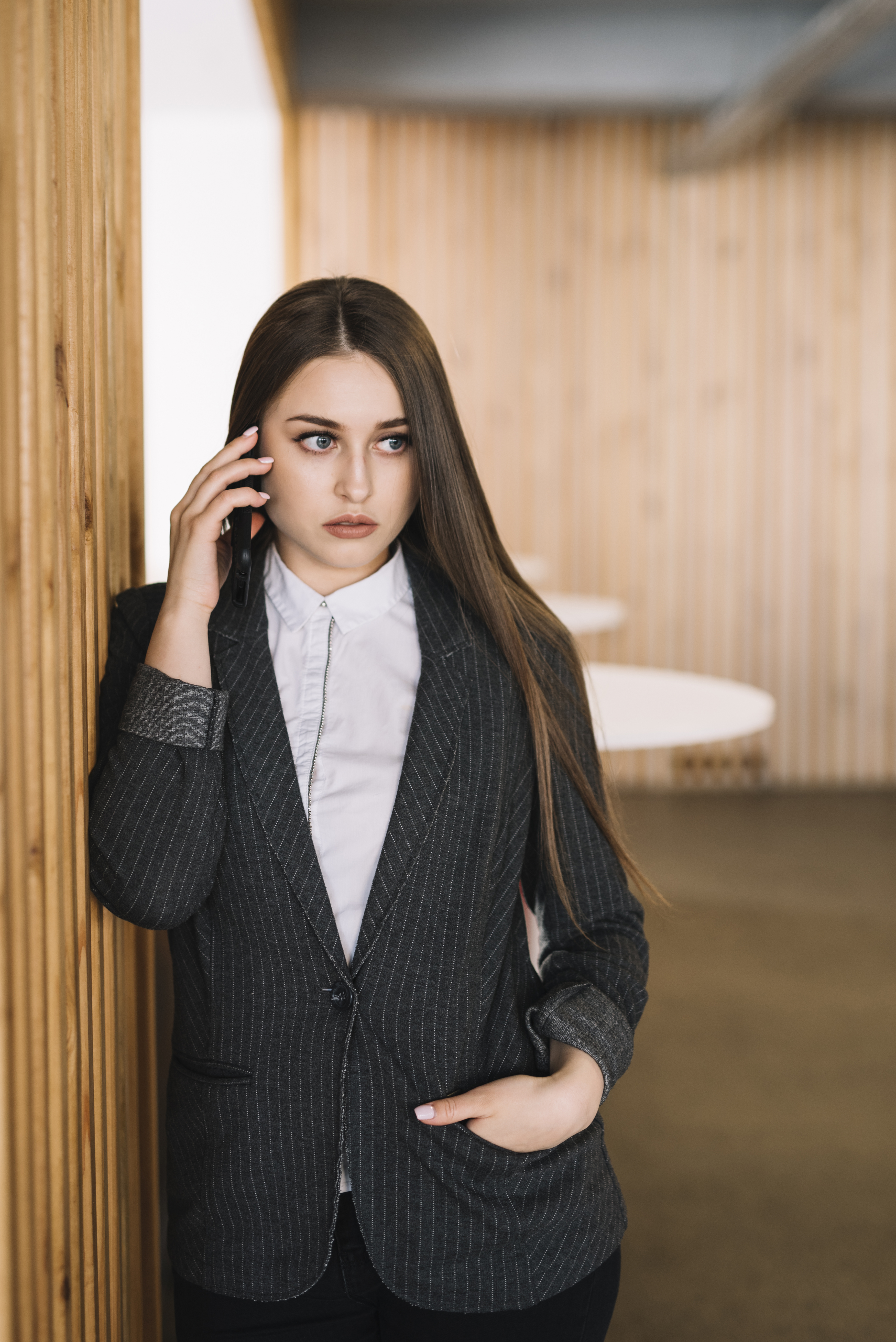 business-woman-talking-by-phone-wall.jpg