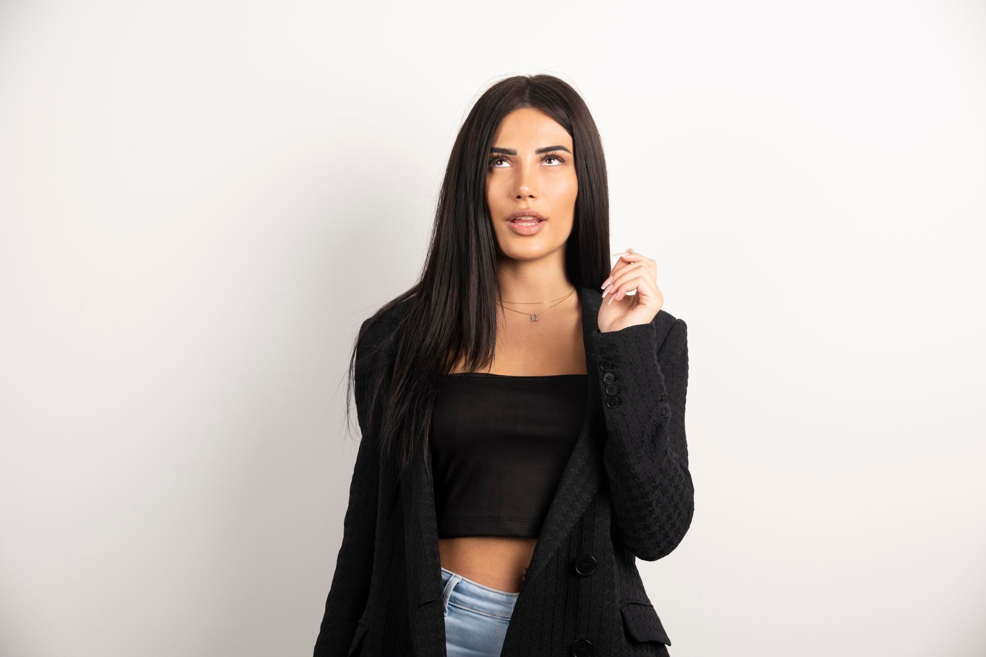 brunette-woman-black-crop-top-covering-her-mouth-high-quality-photo_114579-52862.jpg
